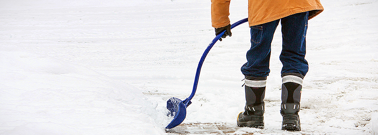 An employee that shovel the snow.