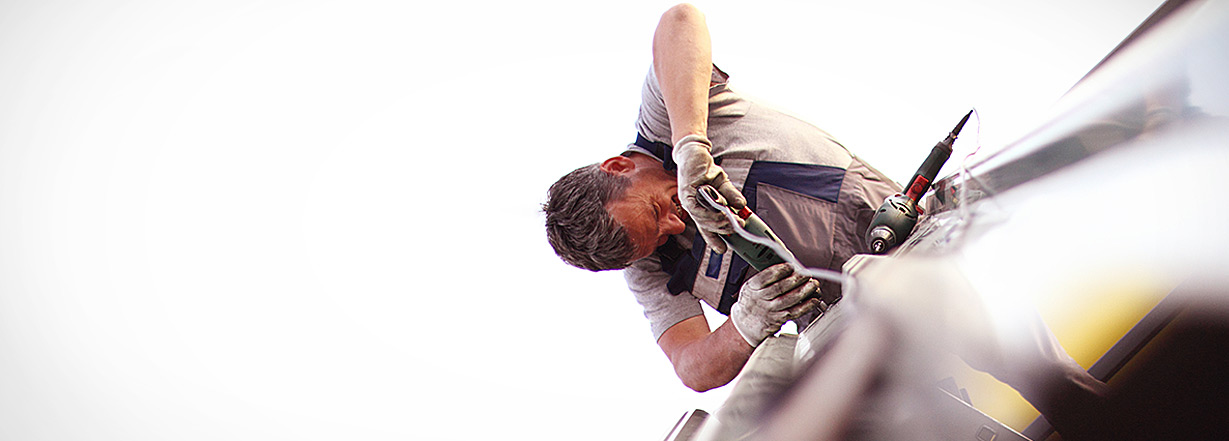 An employee attach a bolt